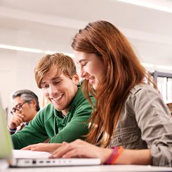 Two young language students sitting at their laptops. 